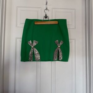 Herringstones Chic Green Mini Skirt with Silver Bow Embellishments